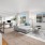 Open concept living room and office space with abundant light