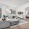 Spacious livingroom with a juliet style balcony and a peek into the master bedroom