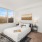 Airy master bedroom with large windows allowing for an abundance of natural light